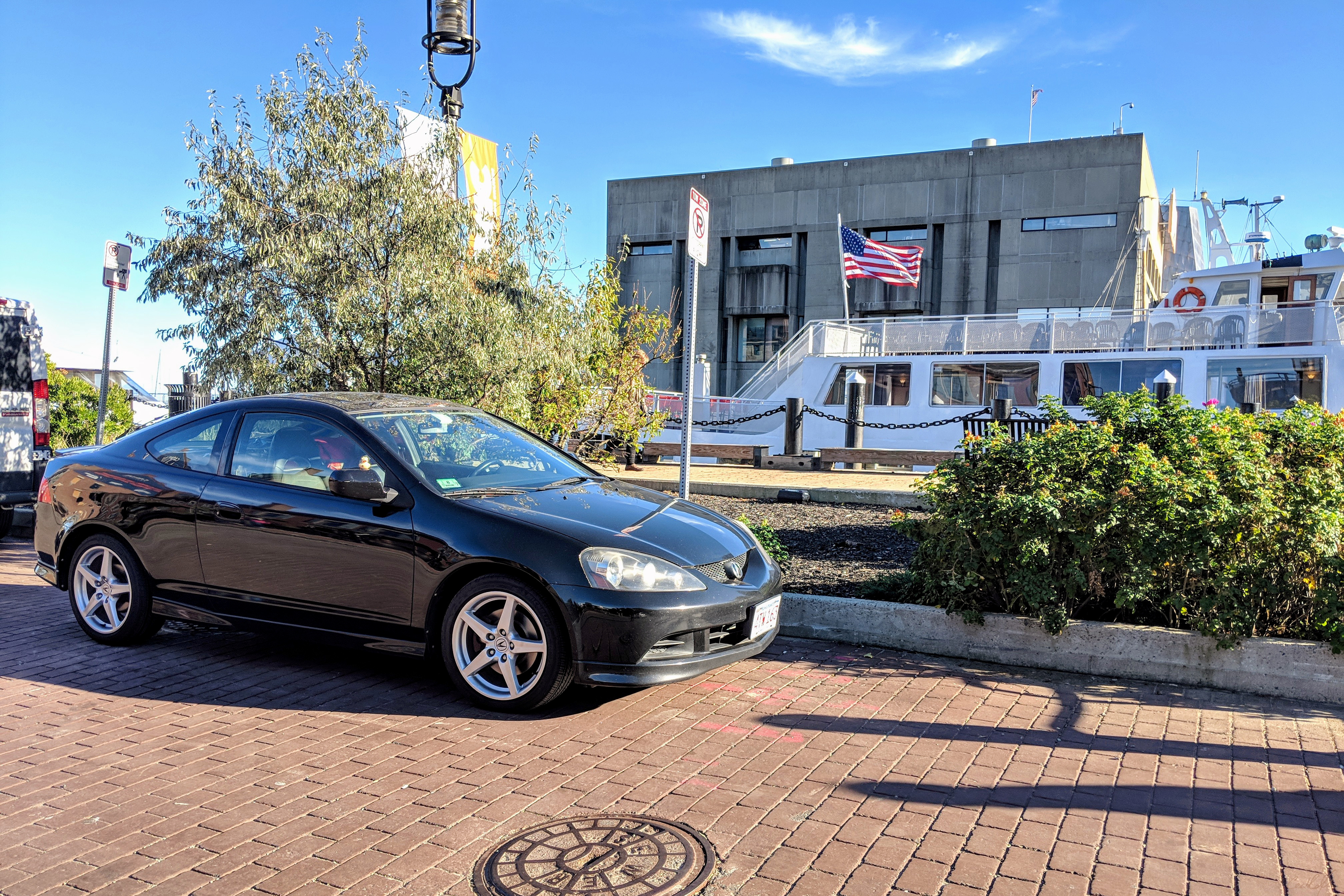 A photo of Bella the rubber duck on my Acura RSX, with Boston Aquarium in the background.